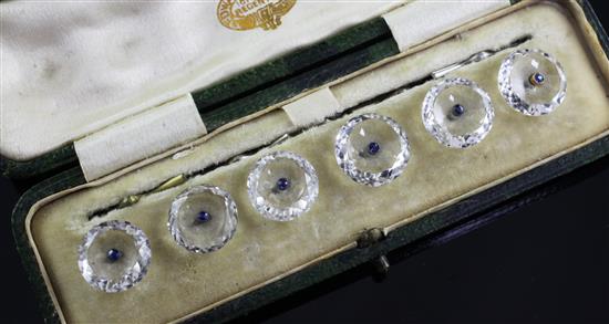 A cased set of six early 20th century rock crystal and sapphire set dress buttons,